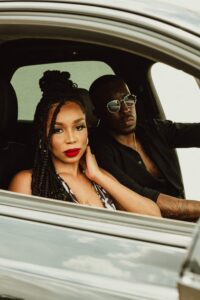 Male model Emanuel Jones, Jr. and a female model sitting in a Bentley Bentayga for a photo-shoot in Dallas, Texas.